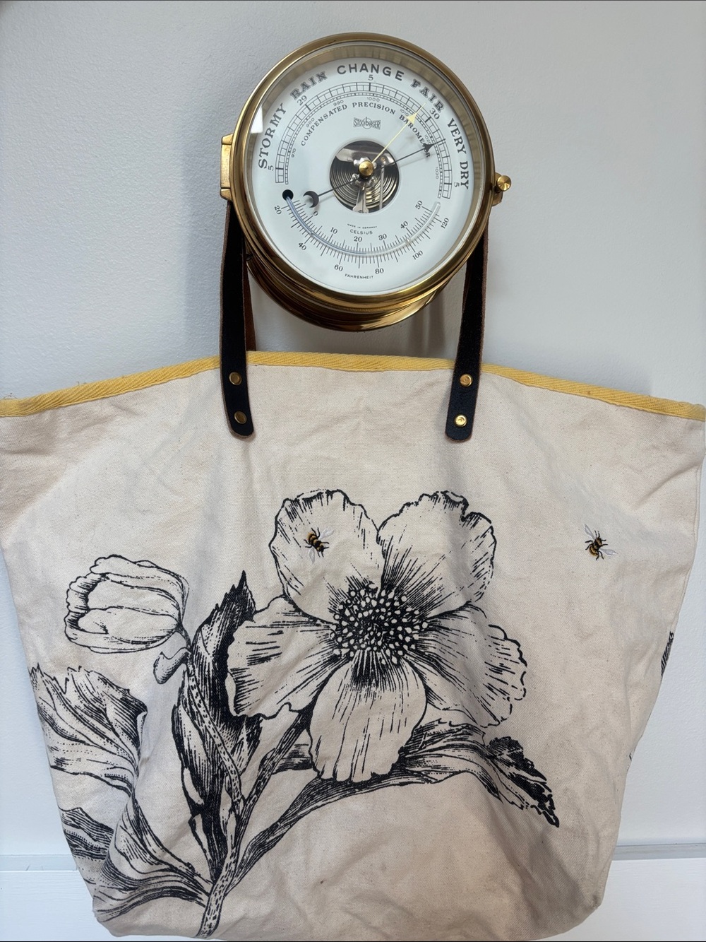Two's Company canvas floral print with embroidered bee details and leather